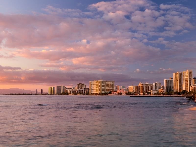 cotton candy looking clouds at the sunset at waikiki out on the water