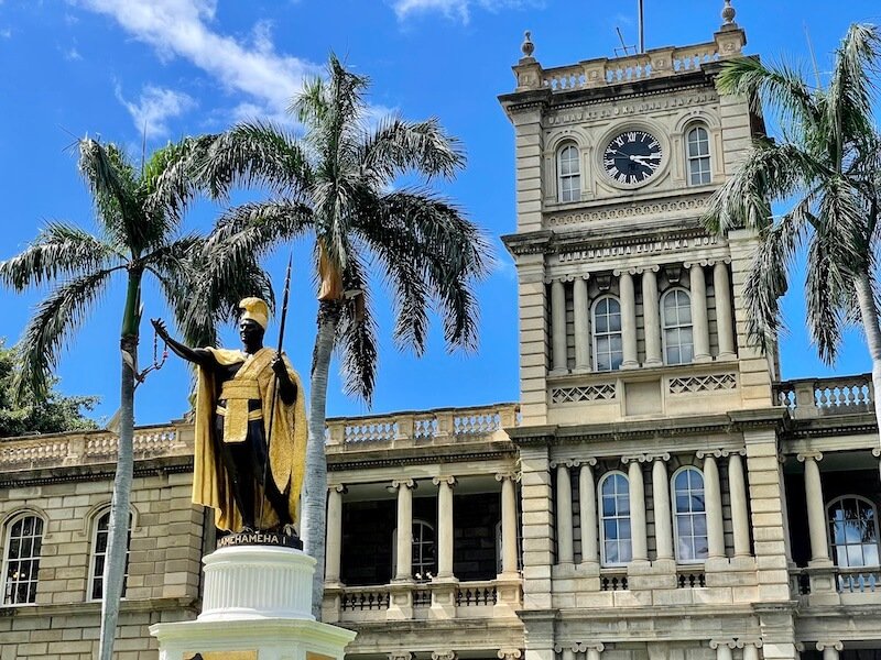 black and gold statue of kamehameha the first and the palatial-looking ali'iolani hale, now the supreme court of hawaii