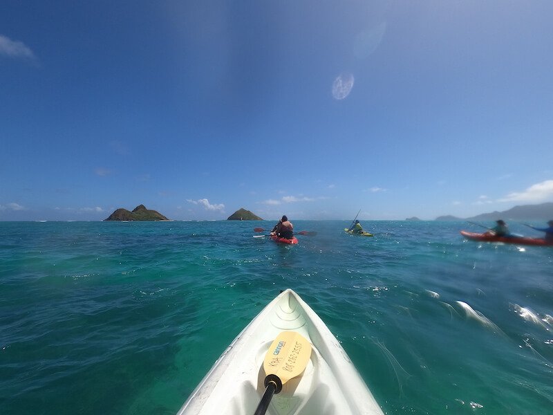 kayaking in kailua bay heading towards two islands with other kayakers on the sea