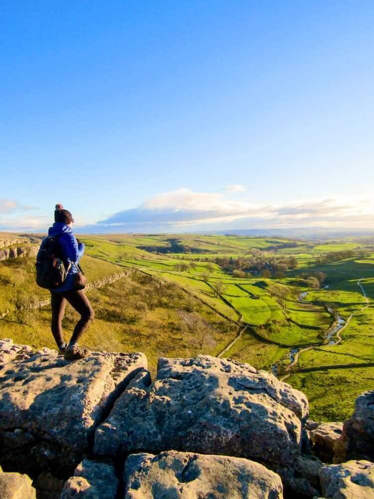 hiker looking out at the scenery along the Hadrian's wall hike