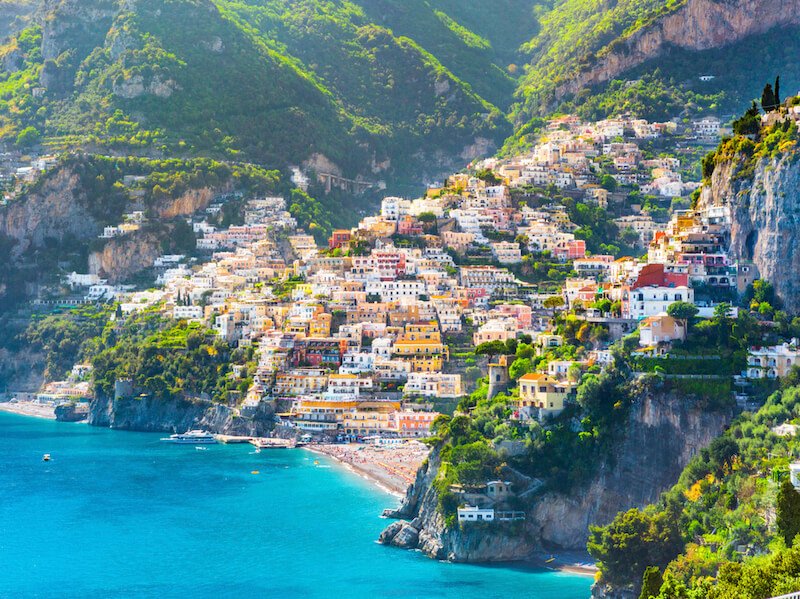 A view of the Cinque Terre in Italy with azure waters from afar