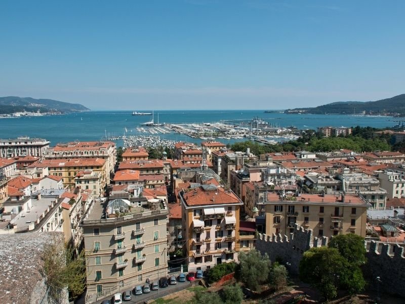 view of the town of la spezia which is the main gateway to cinque terre - view of the buildings of downtown and the harbor and marina and water