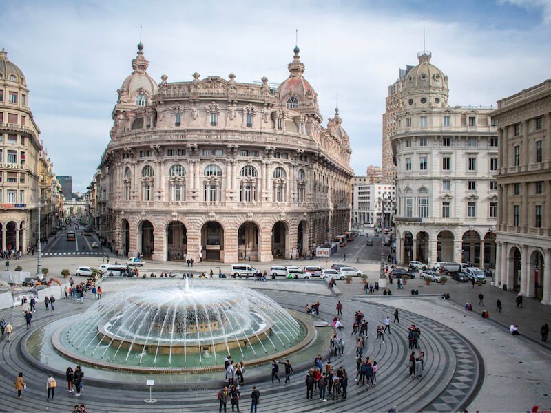The town center of Genoa in Liguria italy with round fountain and ornate buildings in the town center