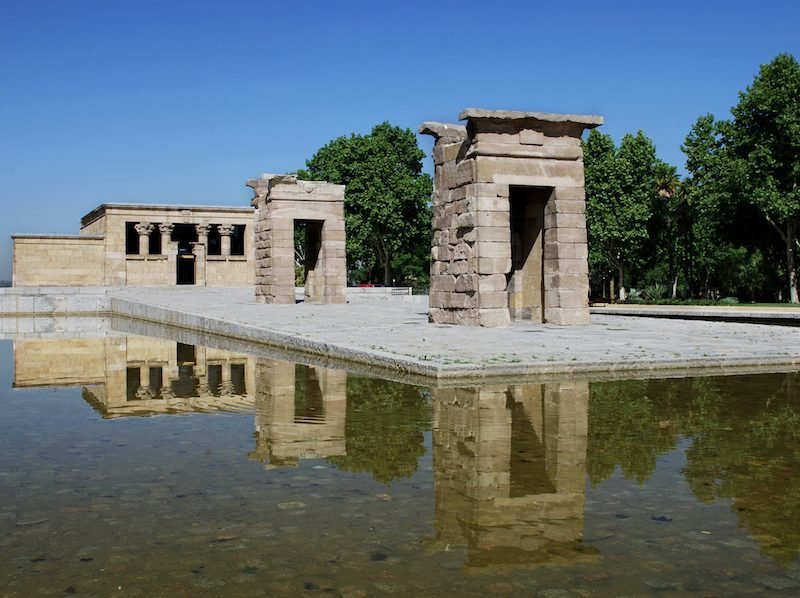 the egyptian temple of debod was a gift from egypt to the city of madrid and stands in the middle of a fountain in the middle of a public park