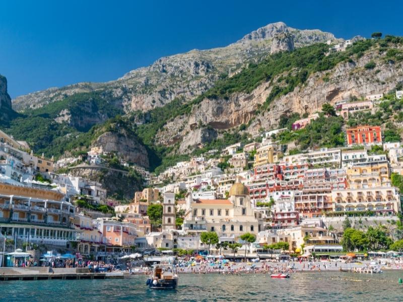 The town of Positano as seen from the water's edge, view of boats and the terraced houses going up the hill