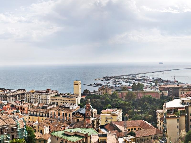 the large town of salerno italy with churches harbor and more