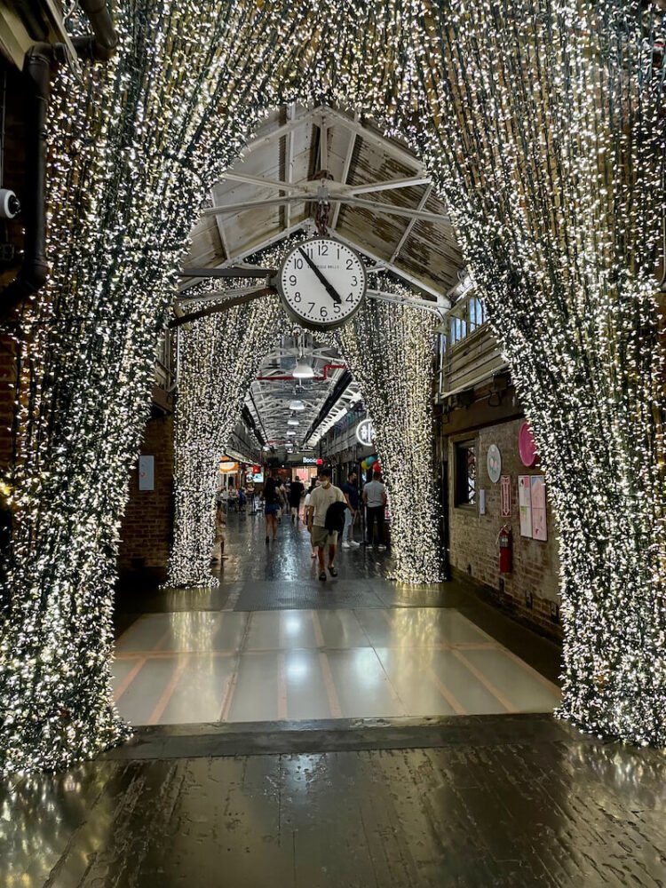 the famous chelsea market in nyc with its central clock and lights inside