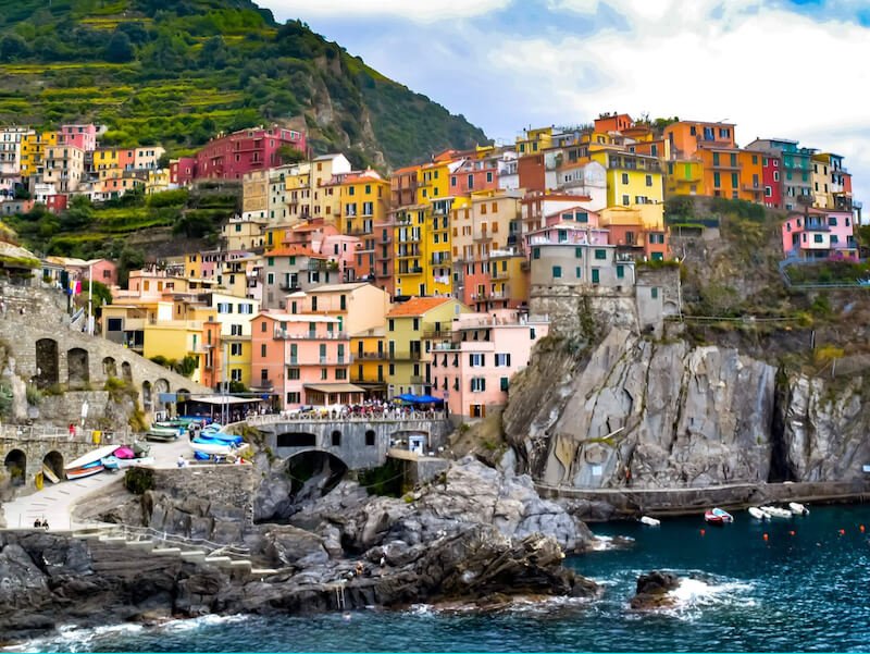 the beautiful cinque terre town on the hillside with colorful houses perched on a cliff