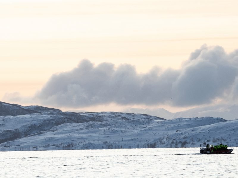 A small inflatable RIB boat with the Skjervoy landscape all around