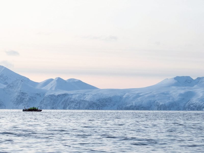 Landscape of the Northern Norway sea side with a small boat out on the water