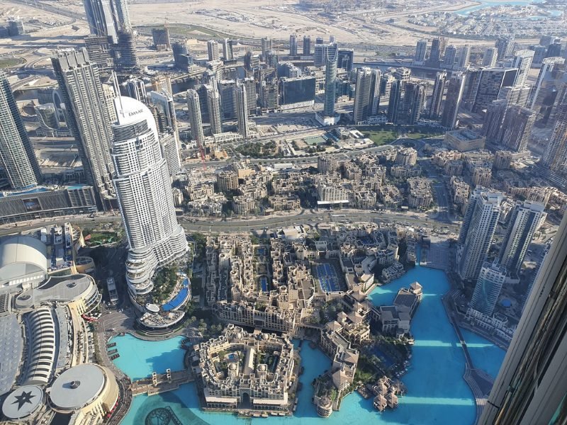 the view from the burj khalifa looking over the cityscape of dubai