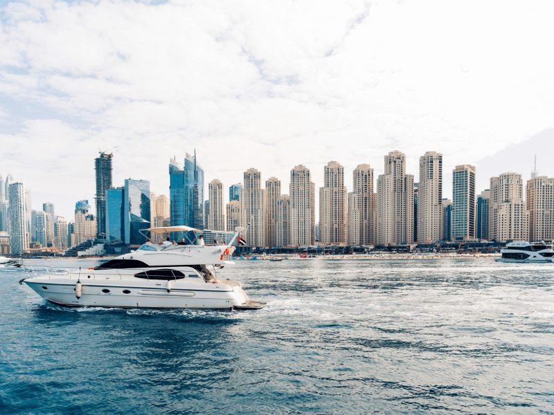 a yacht going past the dubai coastline