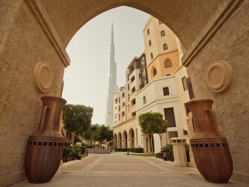 view of more plain-looking buildings of dubai with the burj khalifa in the distance