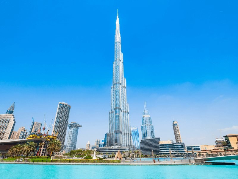 view of the burj khalifa from the exterior with the dubai fountain at its feet and the dubai mall nearby