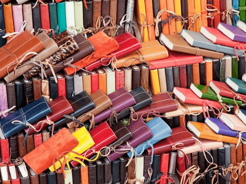 various colors of leather bound diaries and journals in a florence street stall