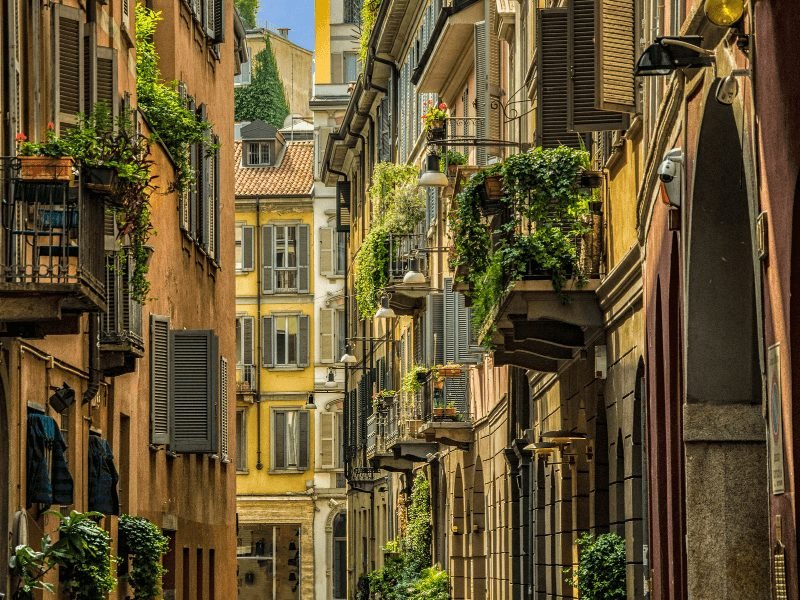 the neighborhood of brera in milan with plant life and balconies and old buildings, very charming and bohemian