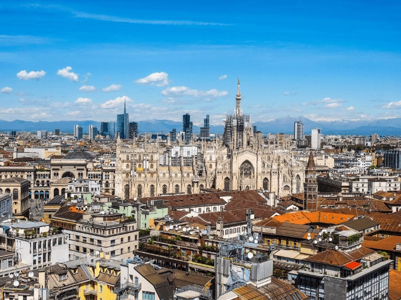 the skyline of milan including the milan cathedral on a sunny day with few clouds in the sky