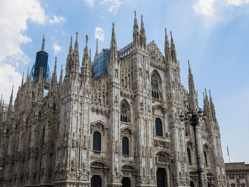 the milan cathedral and its fancy facade and spires on a sunny day in milan italy