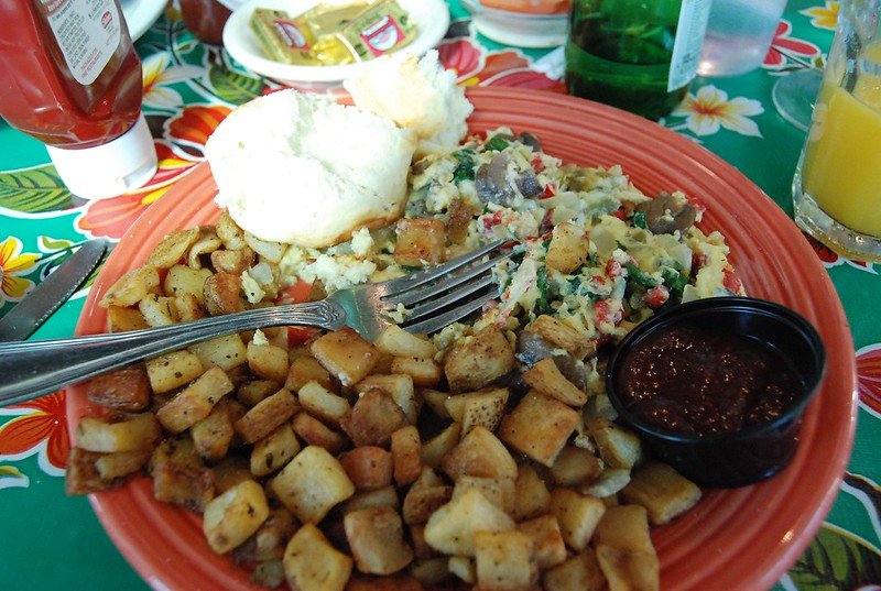 breakfast potatoes, a scramble, jam and a biscuit for breakfast