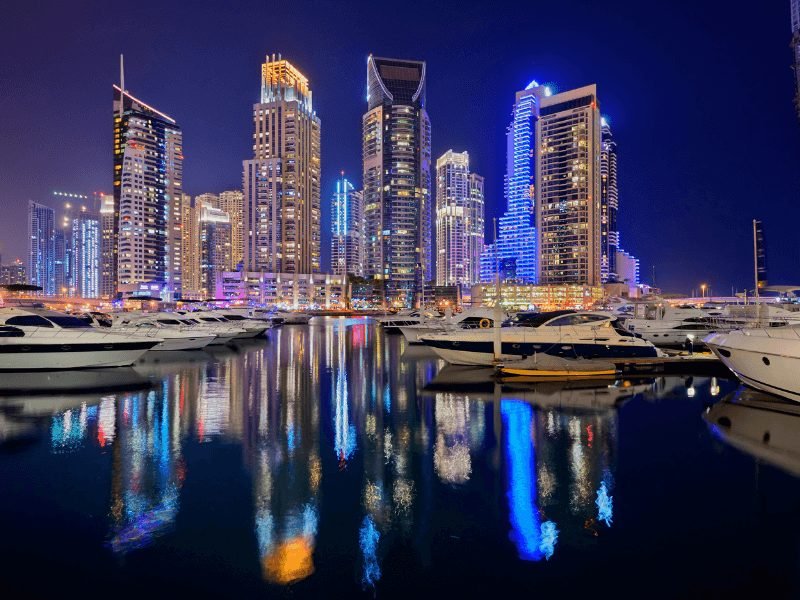 dubai marina speedboats and lit up skyscrapers