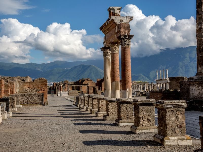 details of pompeii and vesuvius in the background