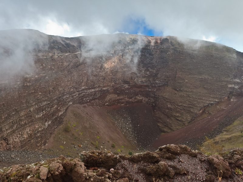 the edge of vesuvius crater with clouds at the top