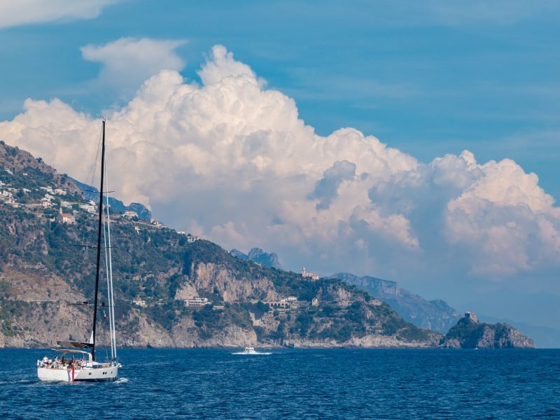 view of a sailboat while traversing the waters by the amalfi coast