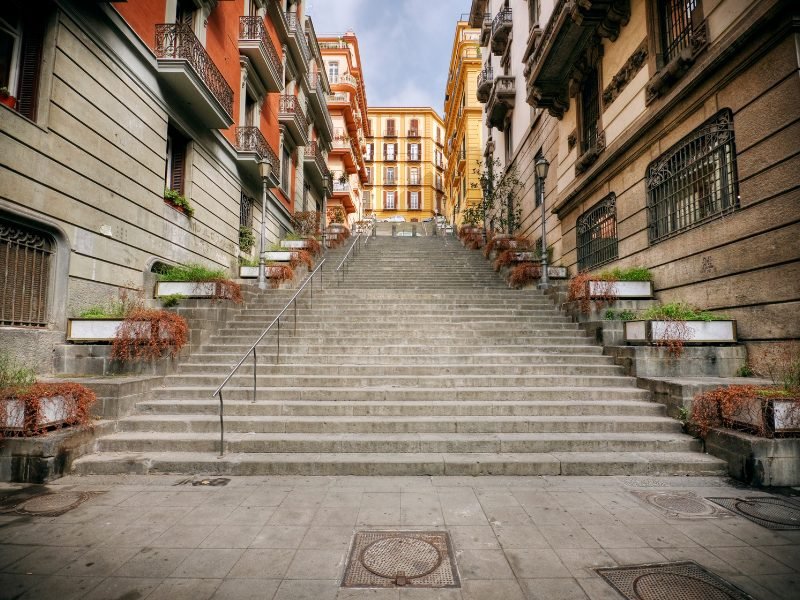 A street scene view in the large Southern Italian city of naples -- staircase, balconies, street scene in the city, with stairs, buildings, etc.