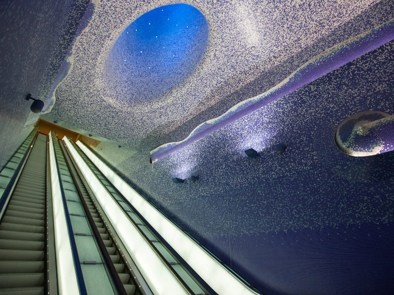 elevators in a naples metro station with a fantastical, galaxy-inspired ceiling design