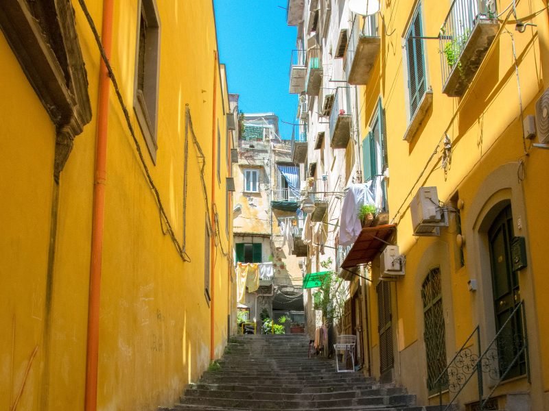 yellow buildings and stairs with laundry showing in typical southern italian fashion