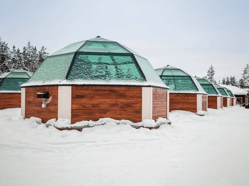 view of glass igloos in finland perfect for northern lights hotels