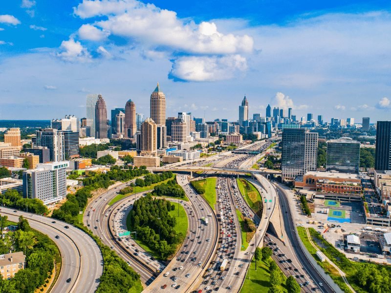 view of atlanta's highways and skyline on a sunny summer day with a few clouds in the sky