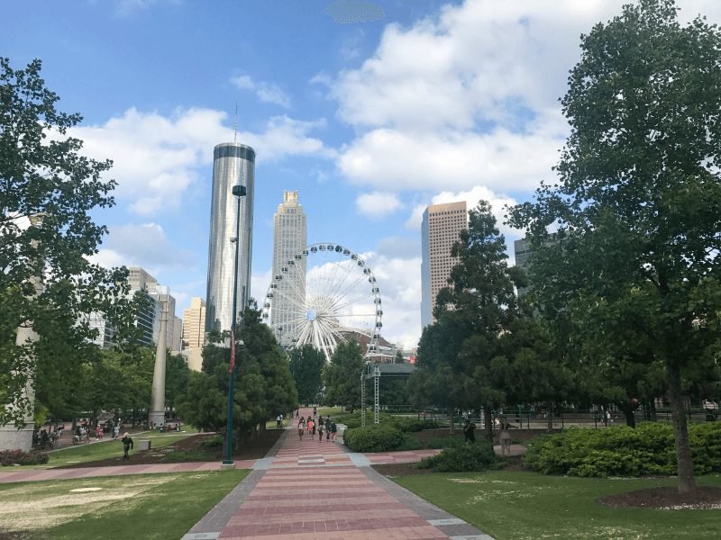 the ferris wheel of centennial olympic park with buildings and skyline in the background