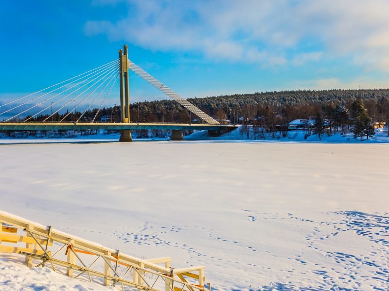 iced over river in rovaniemi in winter