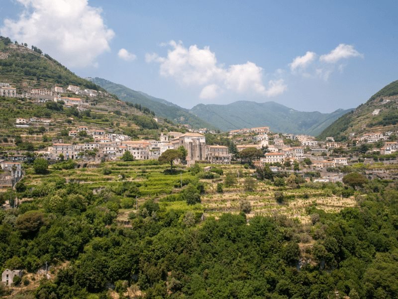 terrace hillside town of scala italy on the amalfi coast with buildings in white and earth tones and lots of greenery and mountains in the background