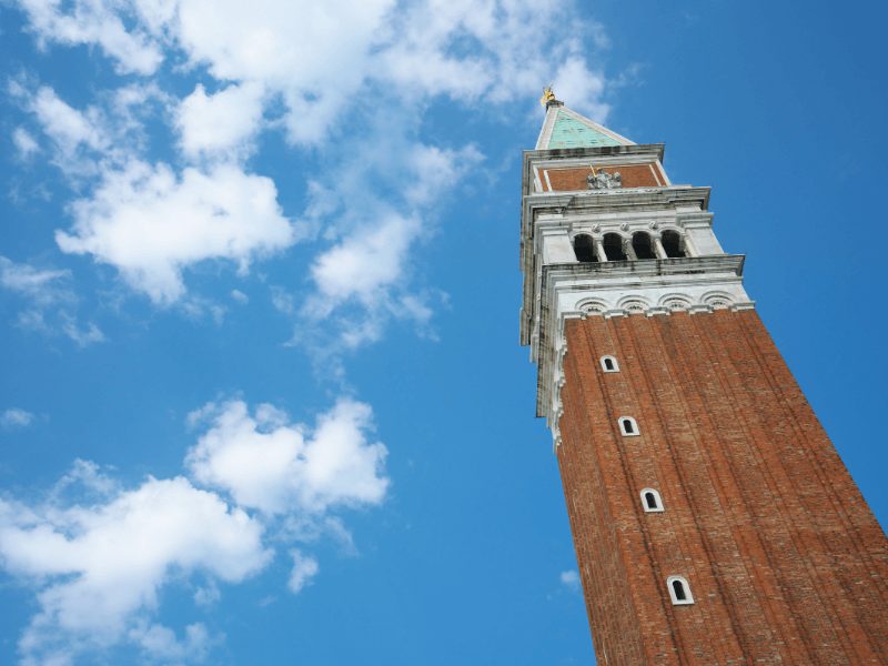 view looking up to the campanile from the ground up on a sunny day with some clouds