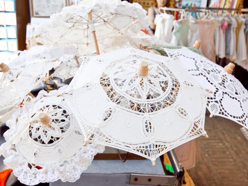 lace umbrellas in venice italy with other works in the background