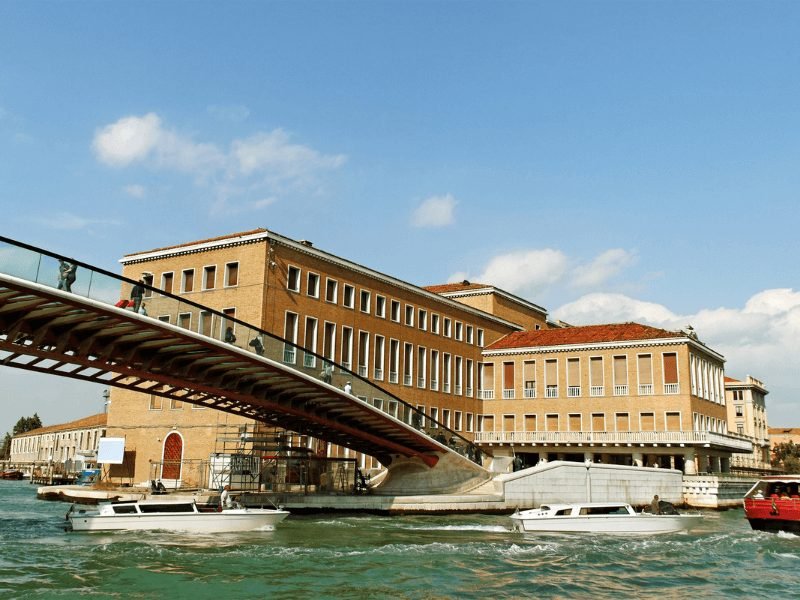 boats and bridge leading to the train station in venice italy