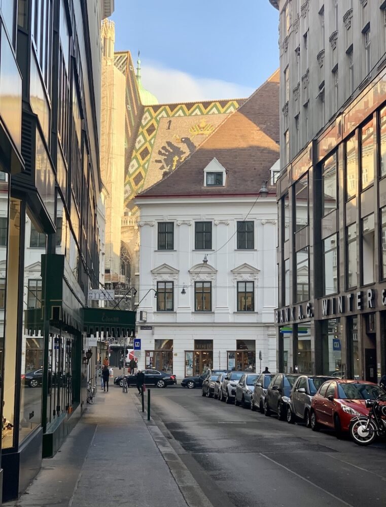 architecture in the vienna city center in the early morning light, shining on a roof in a viennese church