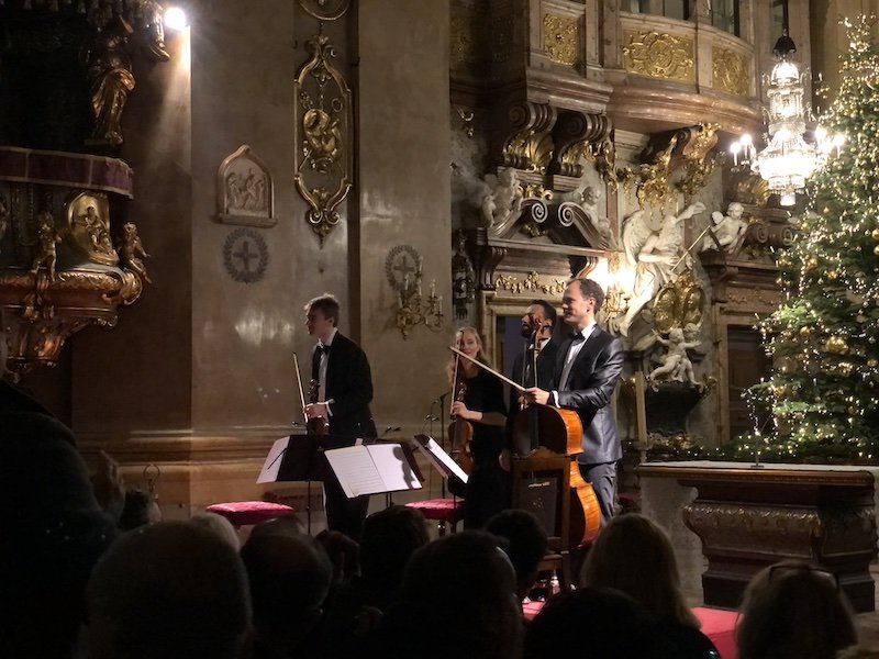 view of people playing music in vienna with a violin and other instruments.