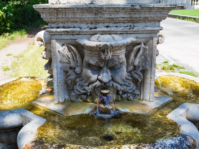 roman water fountain with face and public drinking fountain