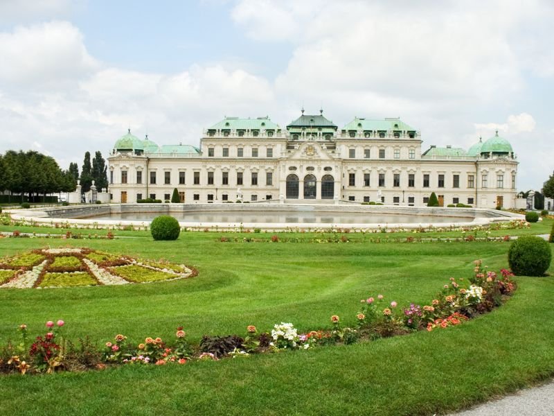 view of the belvedere palace complex with gardens on a cloudy day