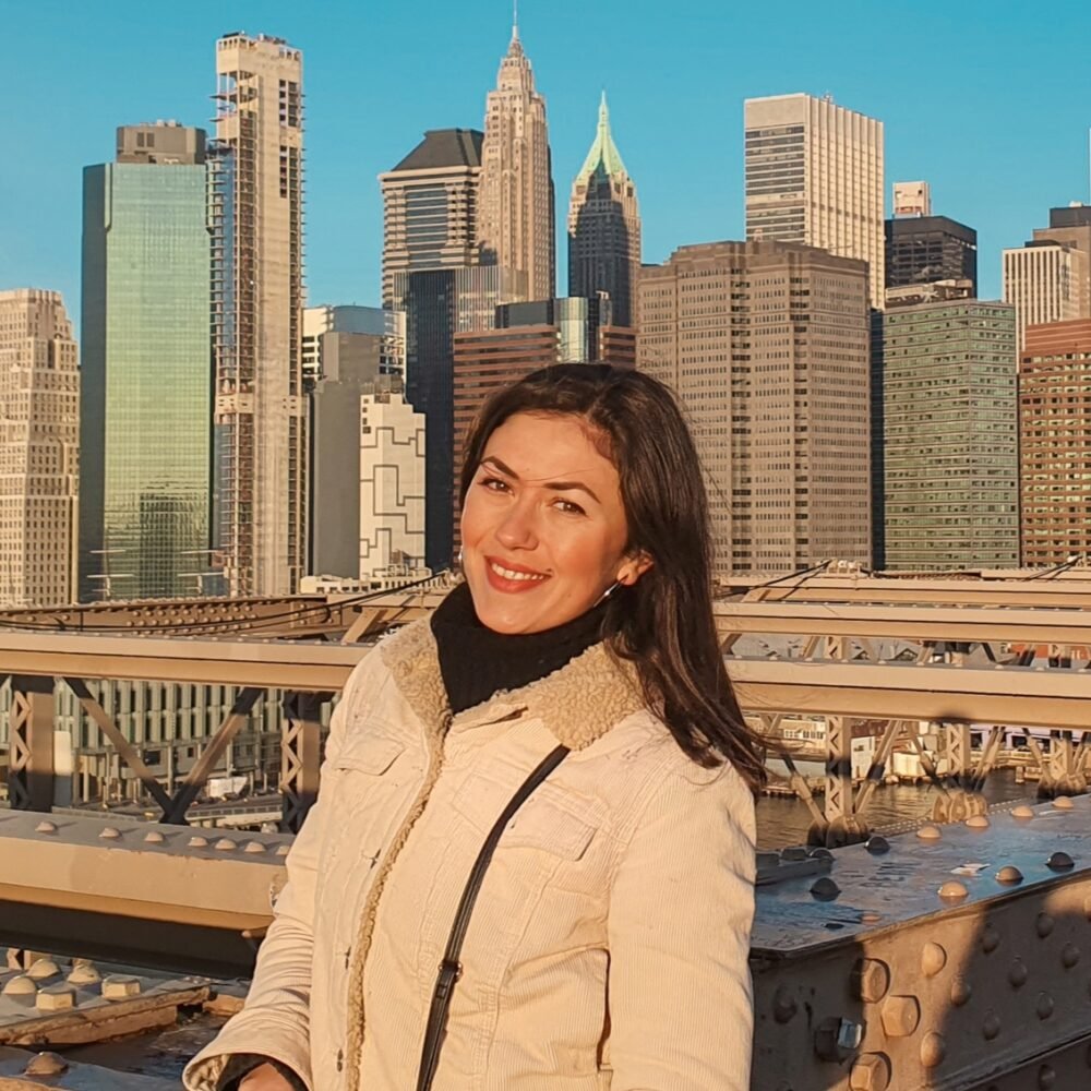 Roxana, an author at Eternal Arrival, in front of the NYC skyline