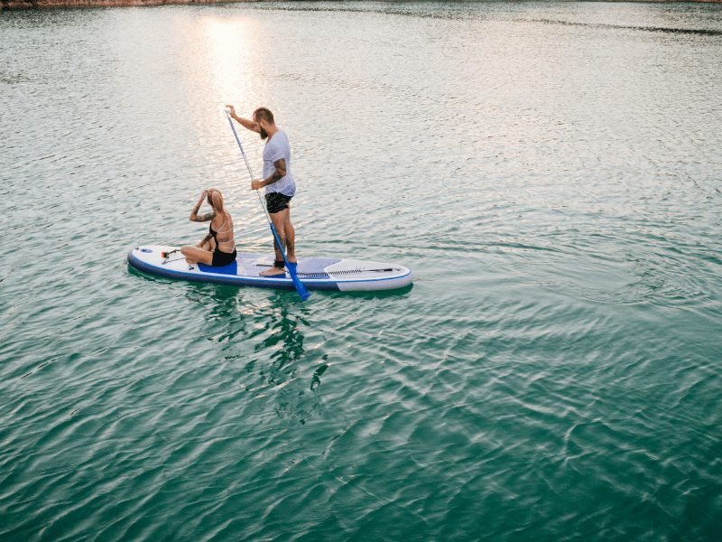 man and a woman on a paddle board enjoying a water sport in Dubai