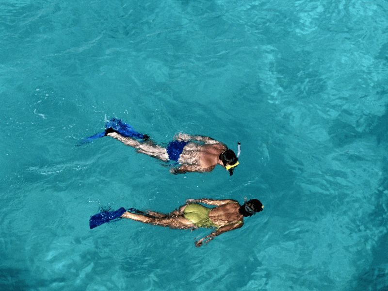 two people snorkeling in deep turquoise blue waters in Dubai, a popular Dubai water sport