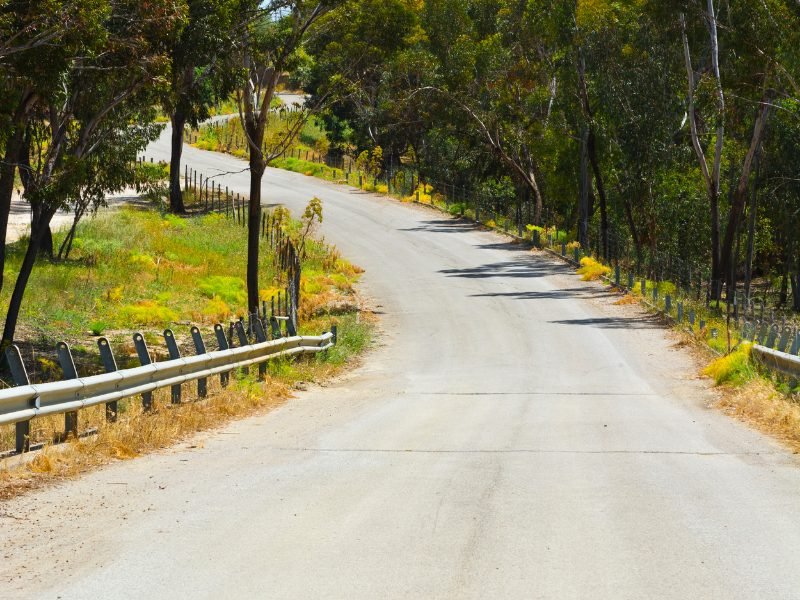 small, narrow winding road in sicily countryside