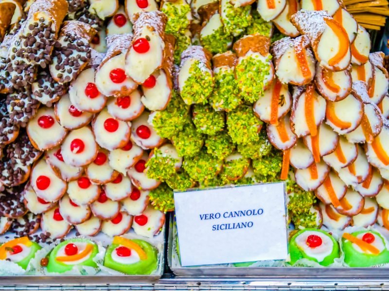 a bunch of different filled cannoli available as street snacks in palermo