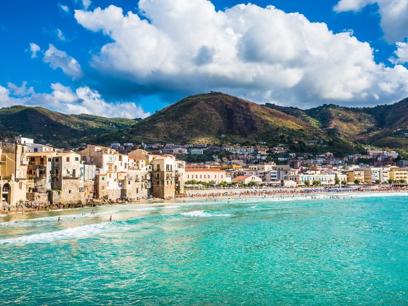 turquoise waters of cefalu beach in sicily on day 3 of this sicily itinerary