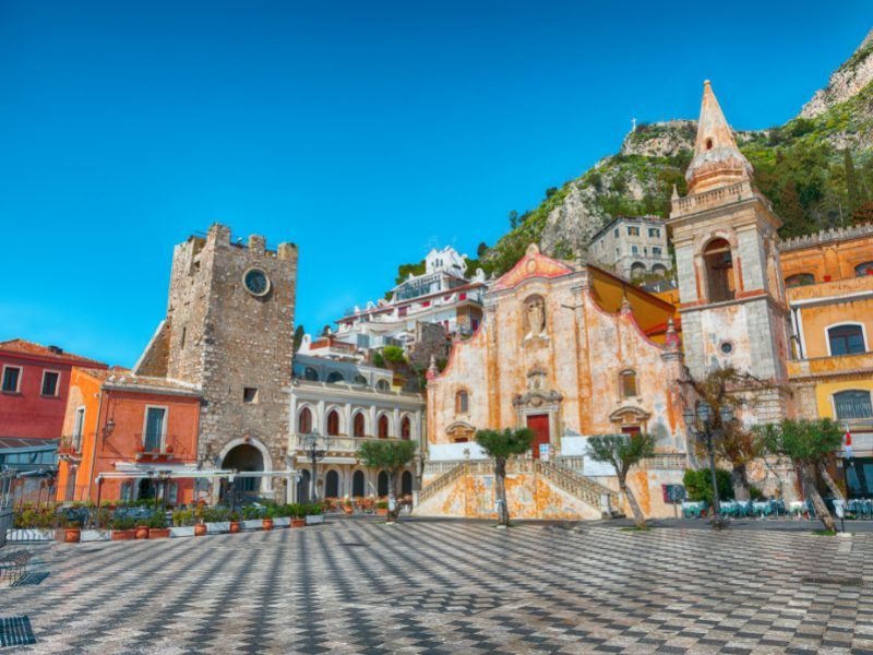 the town square of taormina in sicily with checkerboard floor and old church