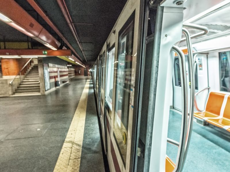 the subway system in rome with orange chairs and an empty train car